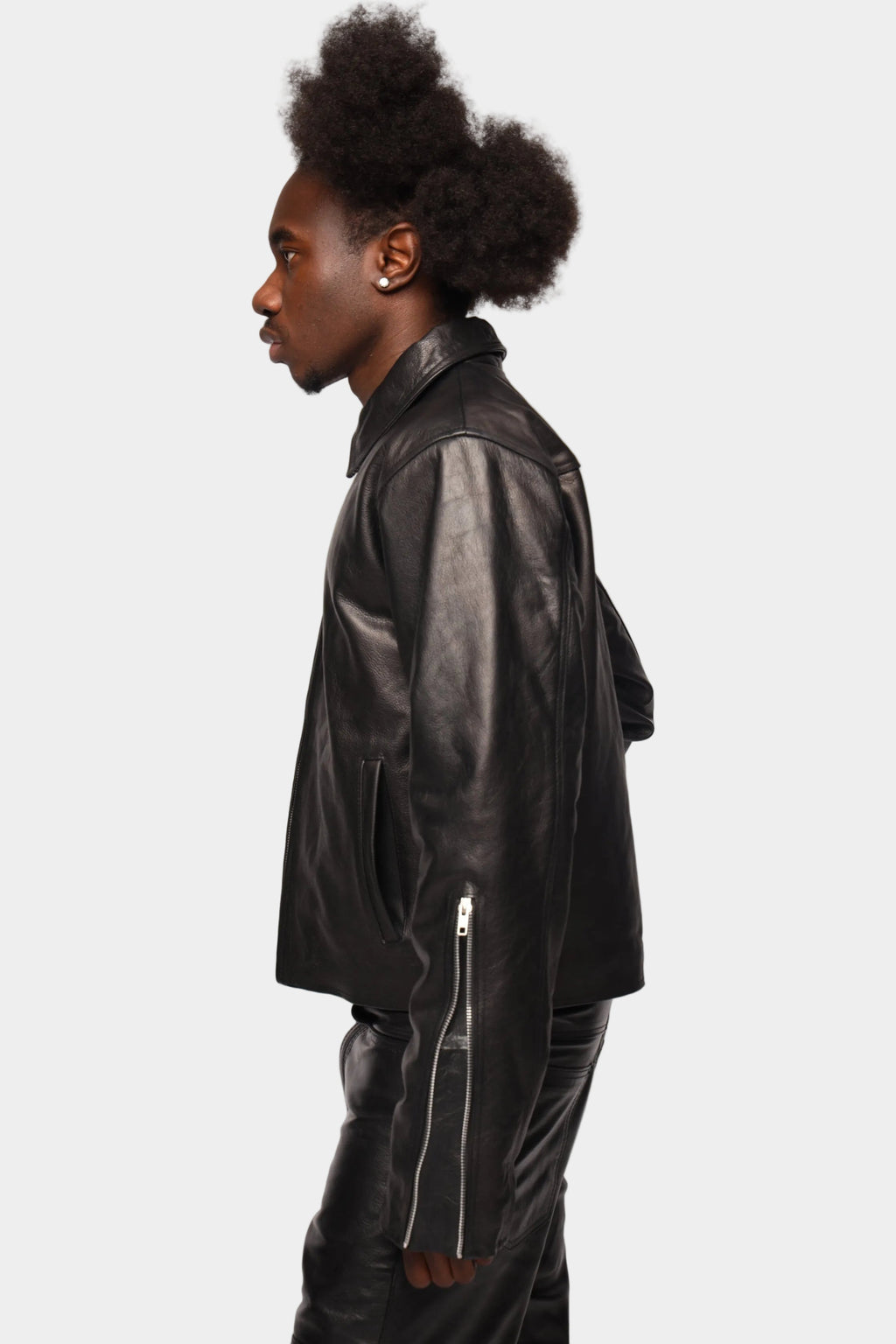Kaleb A. Bearden zipped leather jacket with front zipper, stylish design, and smooth black leather fabric.