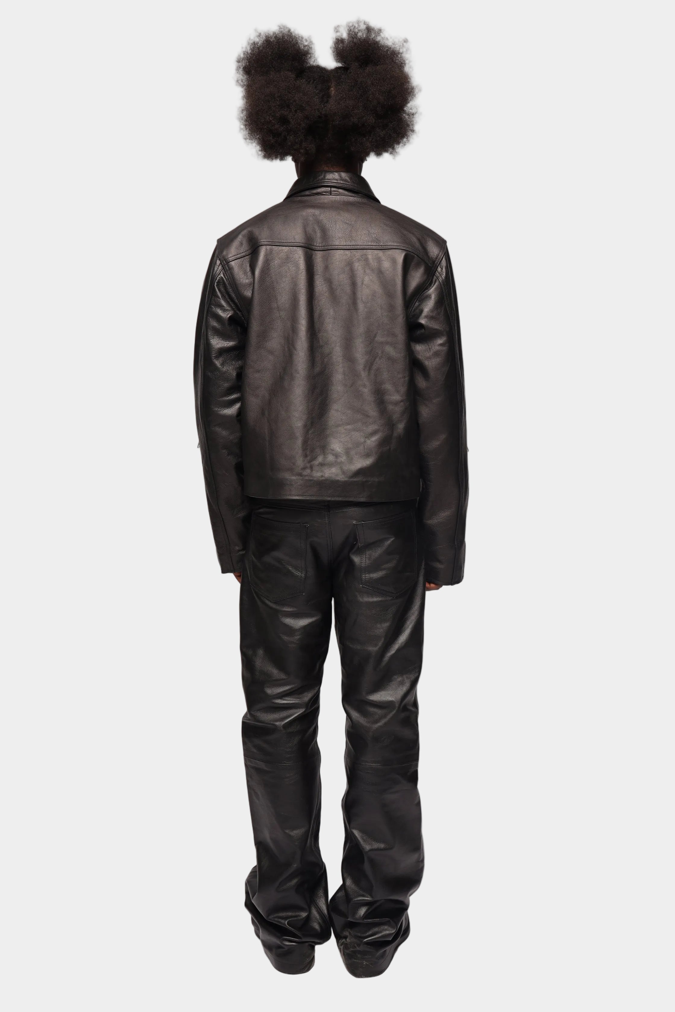 Black zipped leather jacket by Kaleb A. Bearden with a sleek design and silver zipper details.
