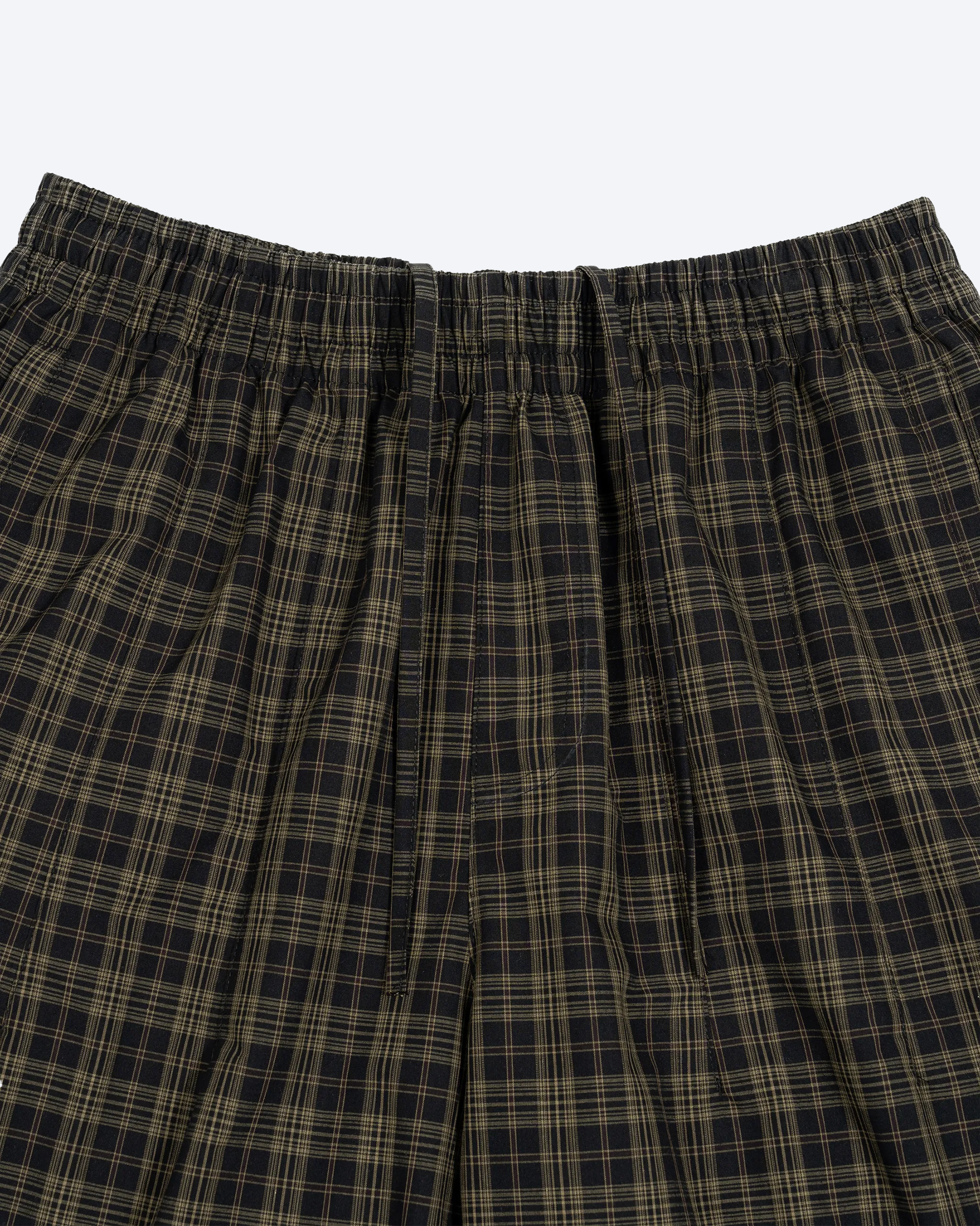 Olive plaid wide-leg shorts by ODMPOD featuring a relaxed fit and casual style, shown on a model with a white background.
