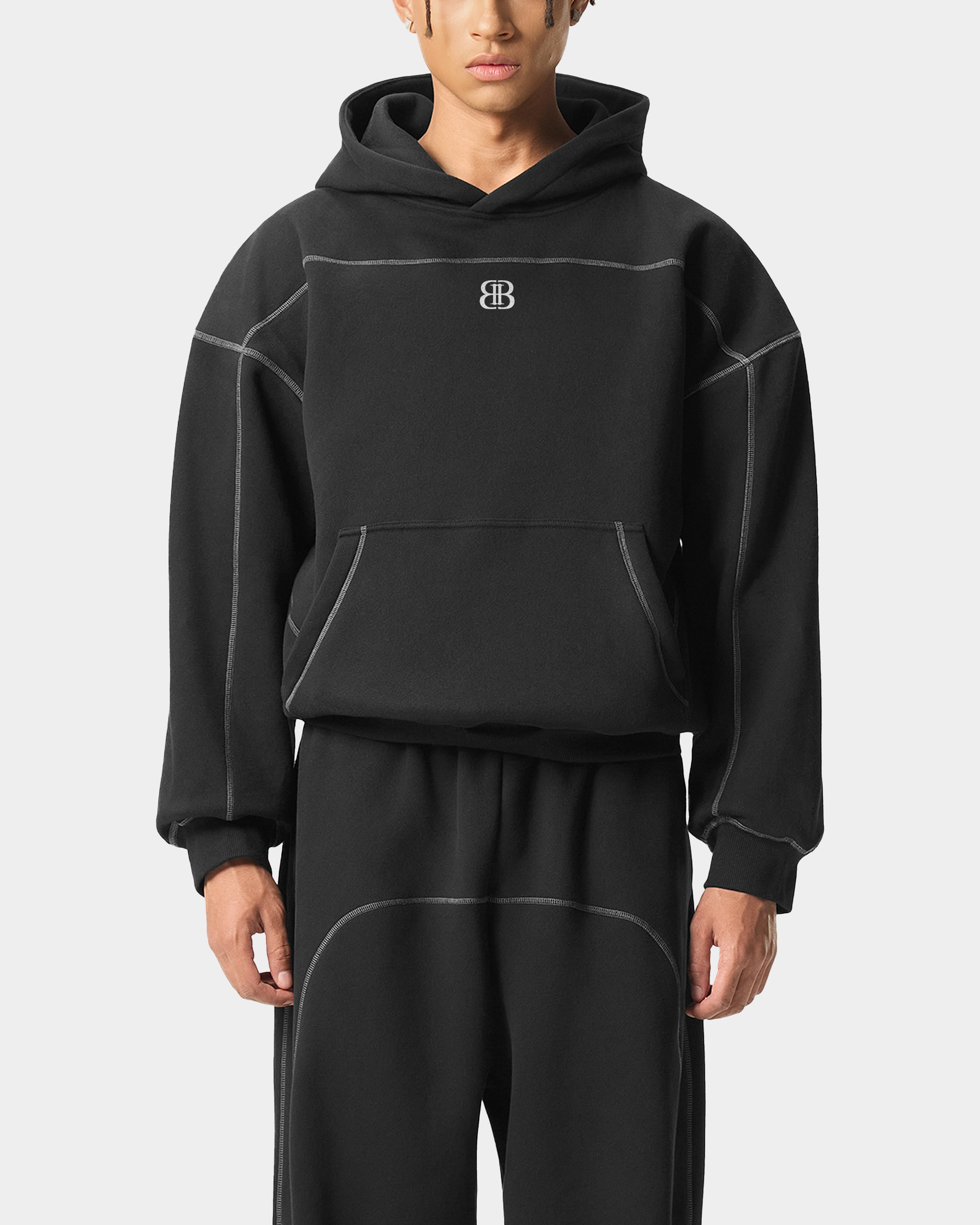 ODMPOD contrast track pants with black and white color blocking, featuring an elastic waistband and tapered fit.