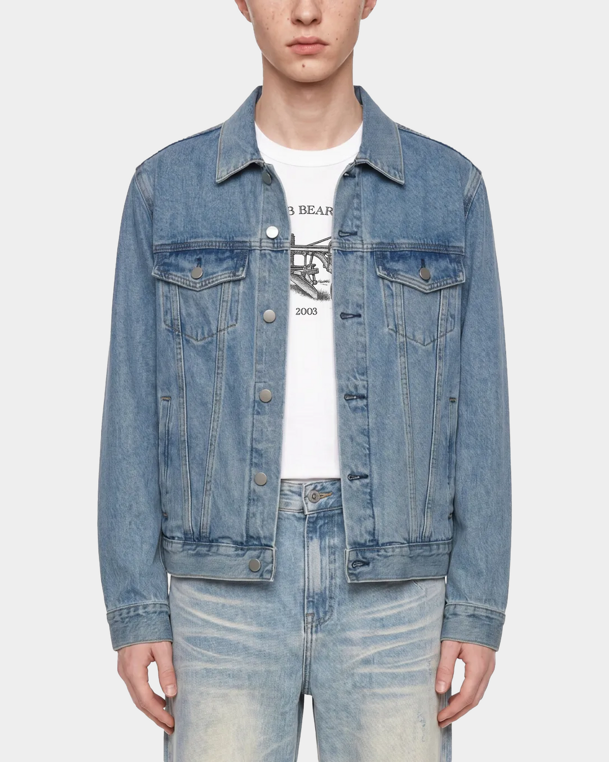 ODMPOD heavyweight denim trucker jacket displayed flat, showing classic collar, button closure, and rugged blue denim fabric.