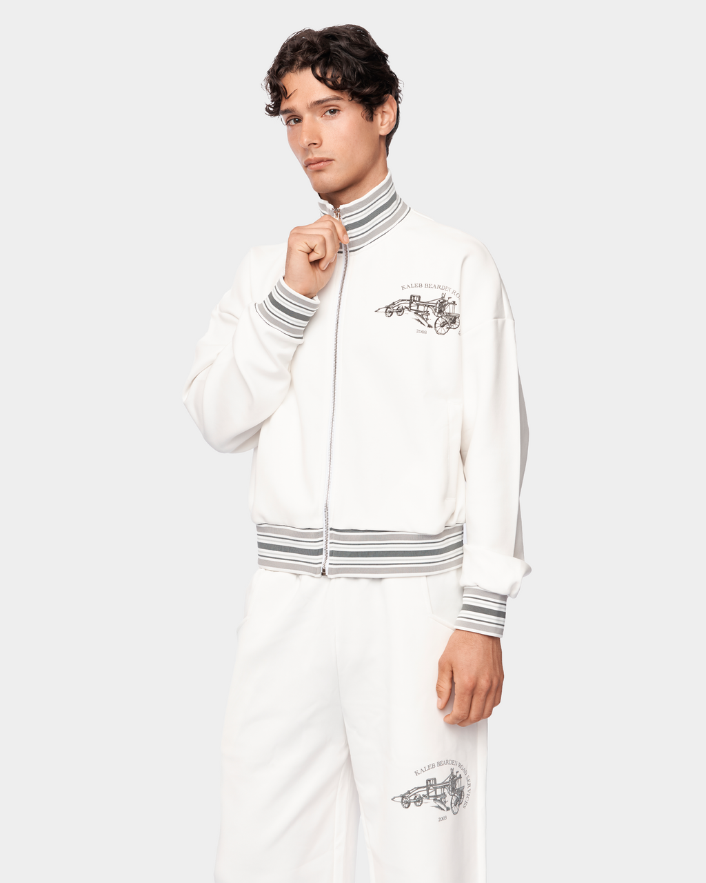 Kaleb A. Bearden Signature Track Jacket in black with zip-up front and athletic fit, shown on a hanger.