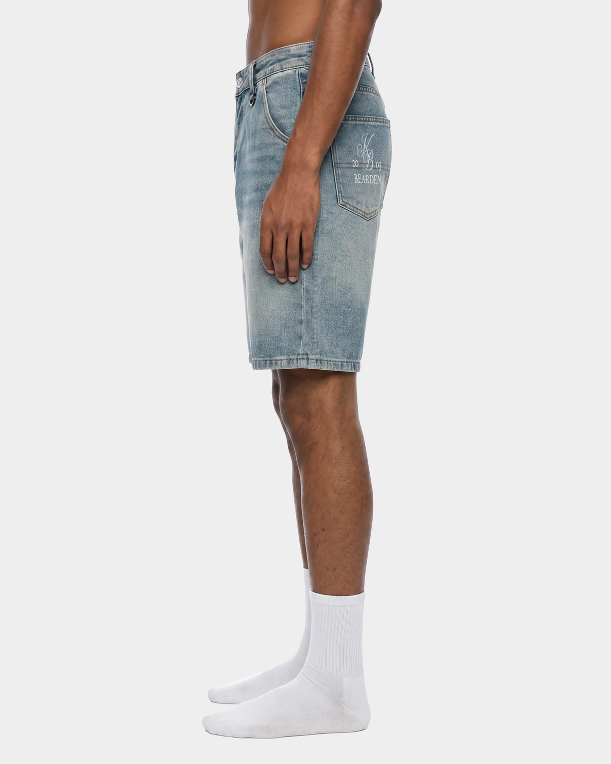 Faded blue denim shorts by ODMPOD with distressed details and rolled cuffs, casual summer style for women.
