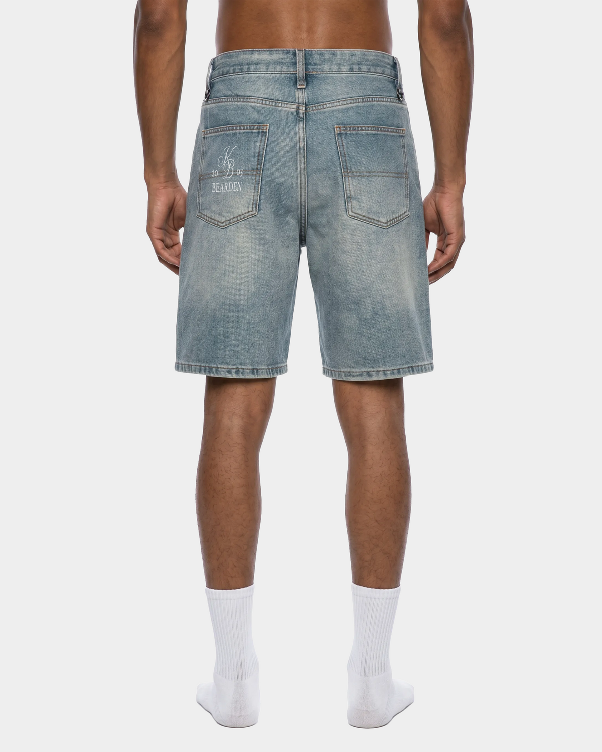 Faded blue denim shorts by ODMPOD featuring distressed details and a casual fit, displayed on a white background.