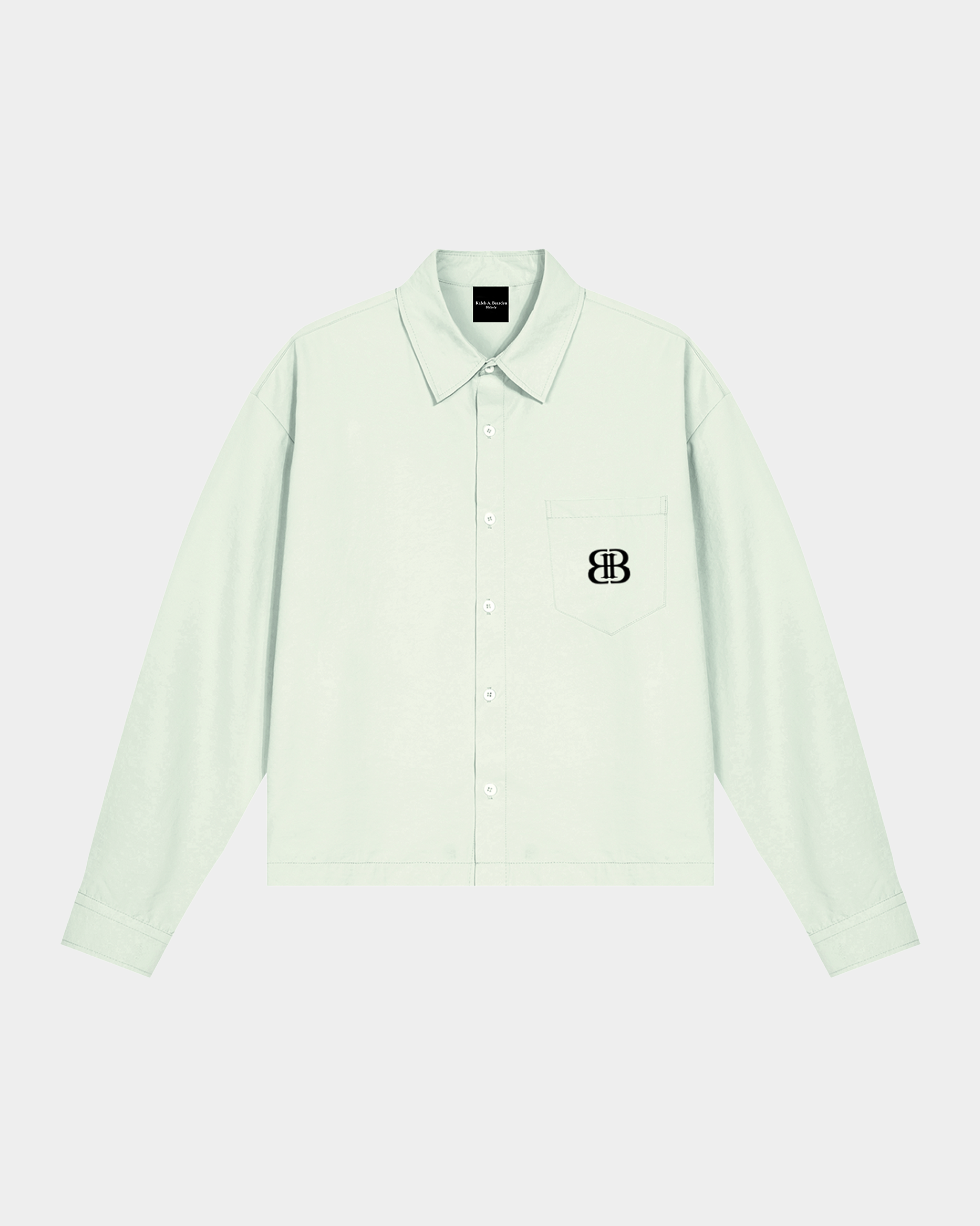 ODMPOD BB Mint Drop Shoulder Shirt displayed on a hanger, featuring a soft mint green color and relaxed fit design.
