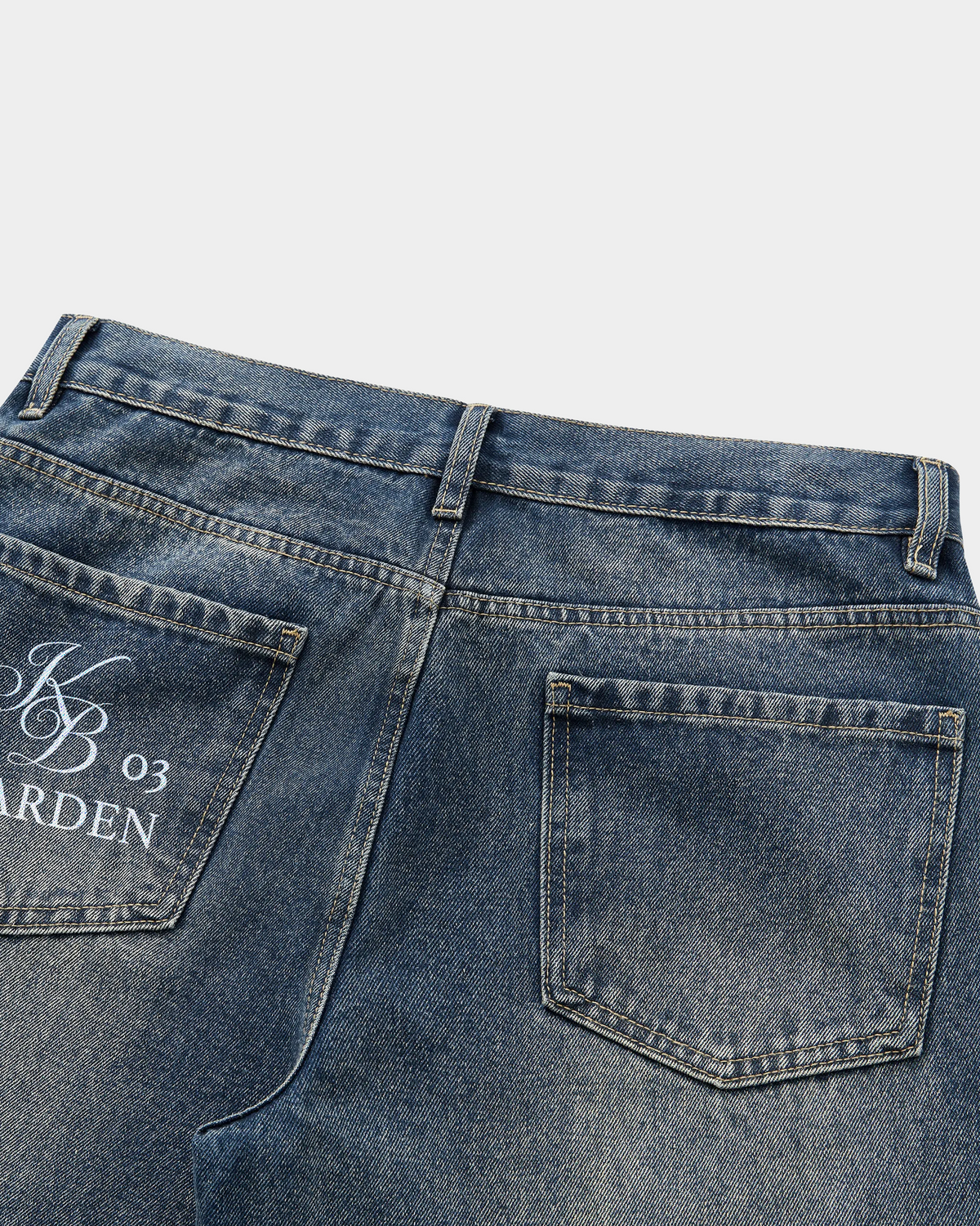 ODMPOD thigh fade straight jeans showing a close-up of the distressed denim with fading and a straight-leg fit.