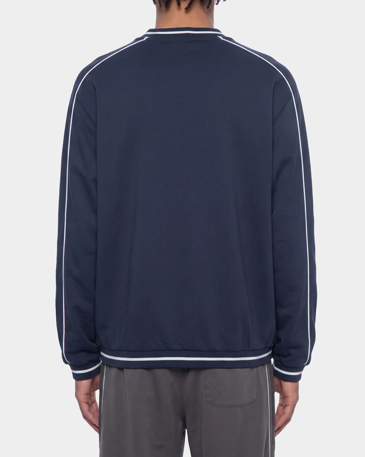 ODMPOD Monogram Raglan Pullover shown in black with white monogram design, casual long-sleeve sweatshirt for everyday wear.