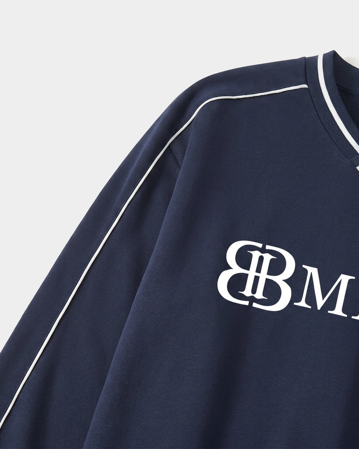 ODMPOD Monogram Raglan Pullover in gray with white sleeves, featuring a stylish monogram design on the front.