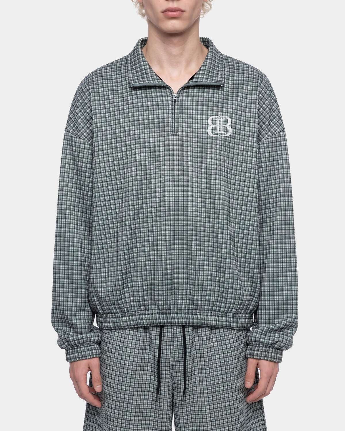 ODMPOD BB Plaid Blouson jacket featuring a classic plaid pattern and lightweight design, ideal for casual wear.
