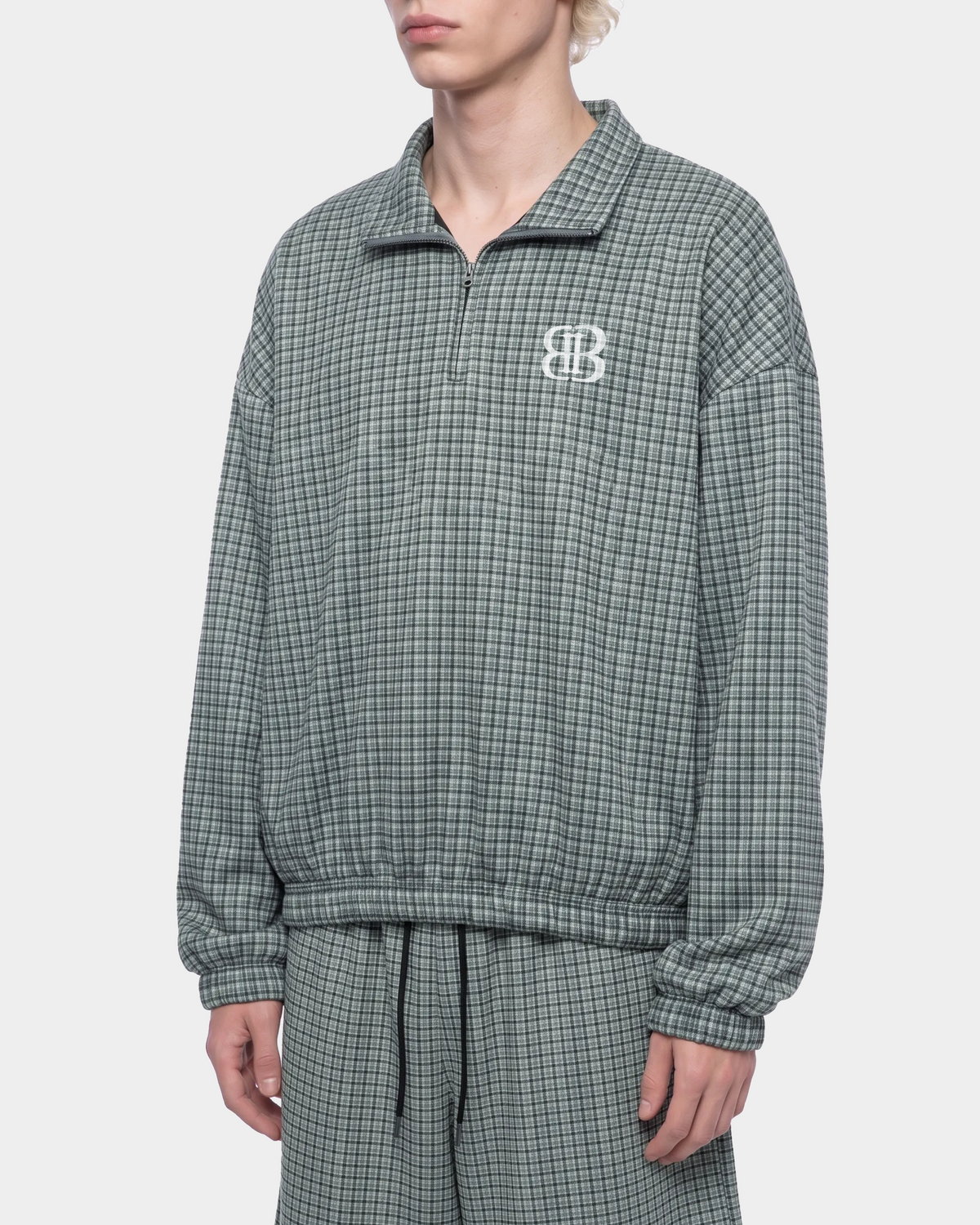 ODMPOD BB Plaid Blouson jacket with button front and ribbed cuffs, featuring a stylish plaid pattern and relaxed fit.