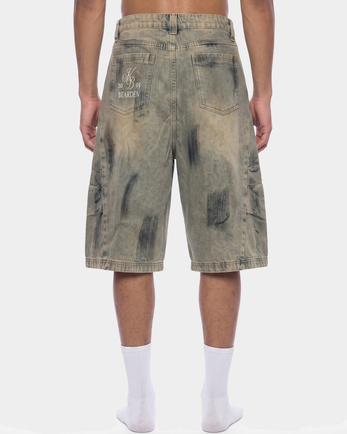 ODMPOD bleach splatter denim shorts showing distressed hem and bleach design on light wash denim.