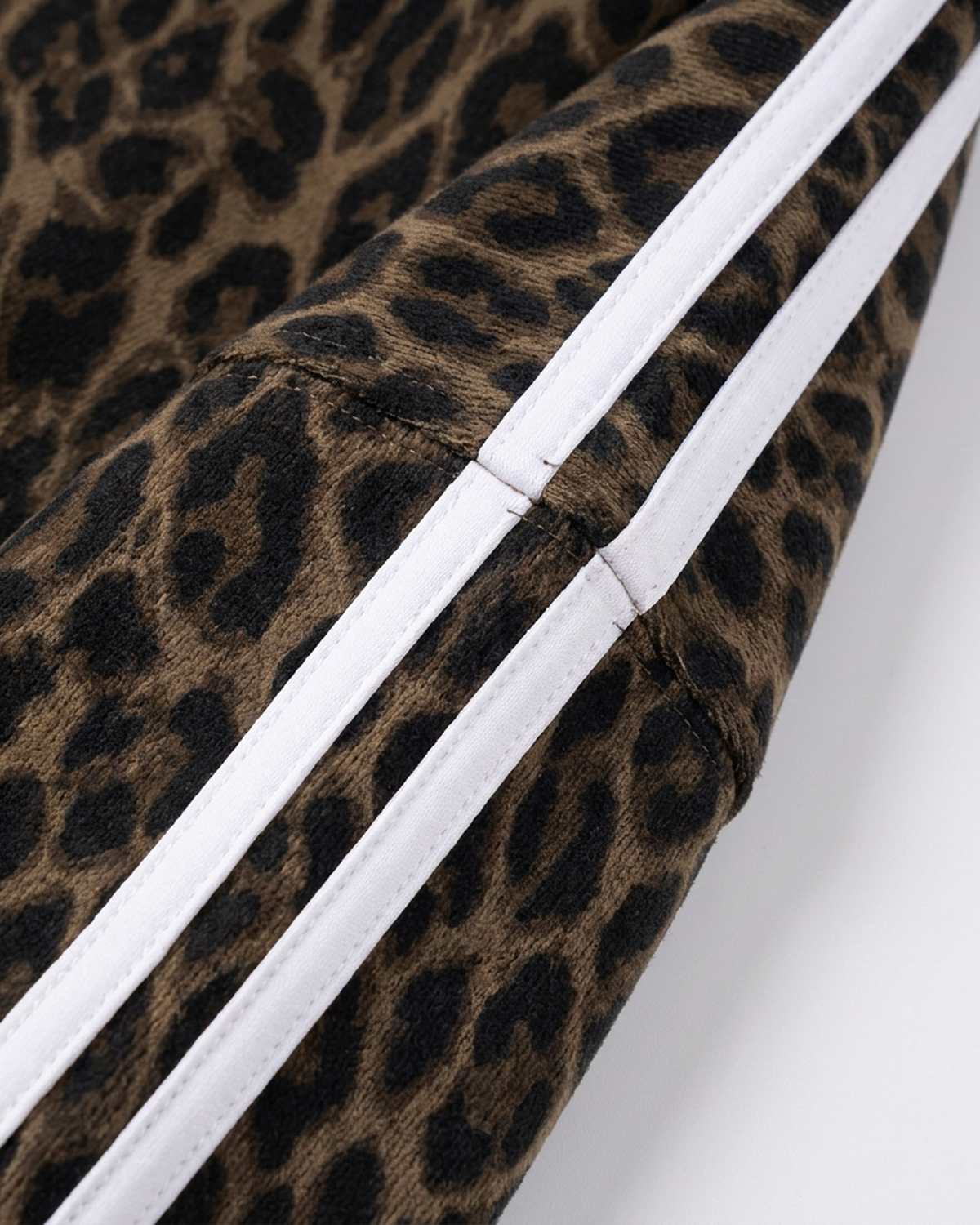 ODMPOD BB Leopard Stripe Zip Hoodie featuring a bold leopard and stripe pattern, with a front zipper and casual fit.