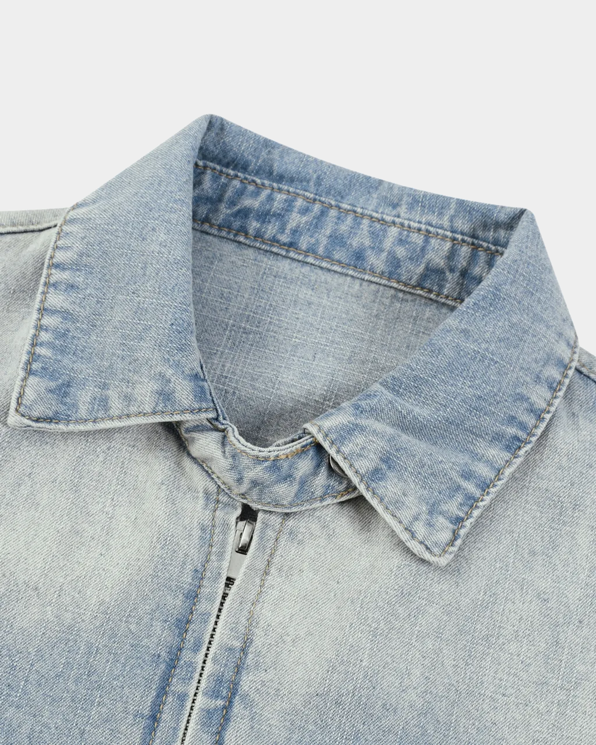 ODMPOD KAB Washed Blouson jacket in light denim with distressed details and relaxed fit, shown on a hanger.