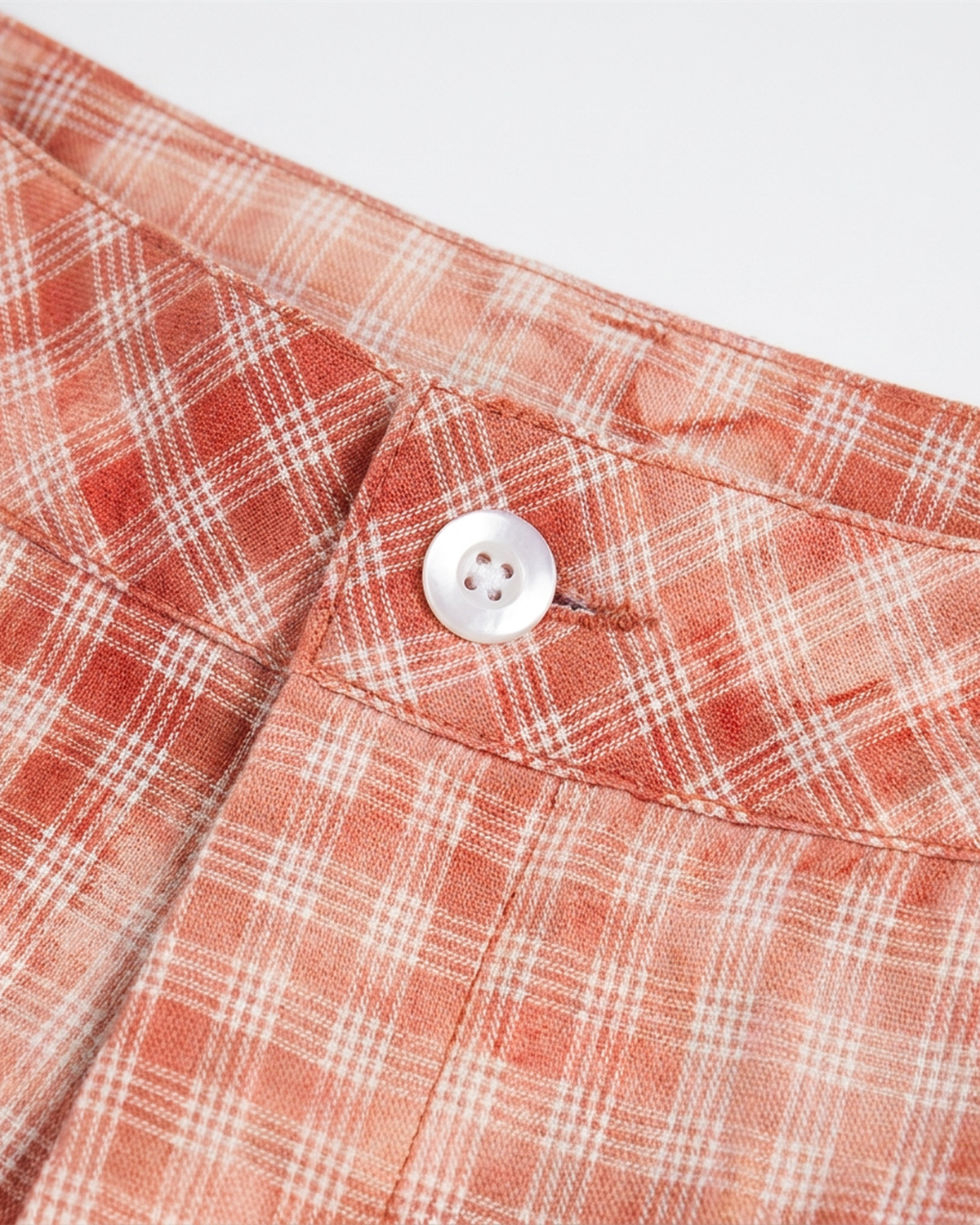 ODMPOD terracotta plaid short with a relaxed fit, featuring a classic checkered pattern and casual style.
