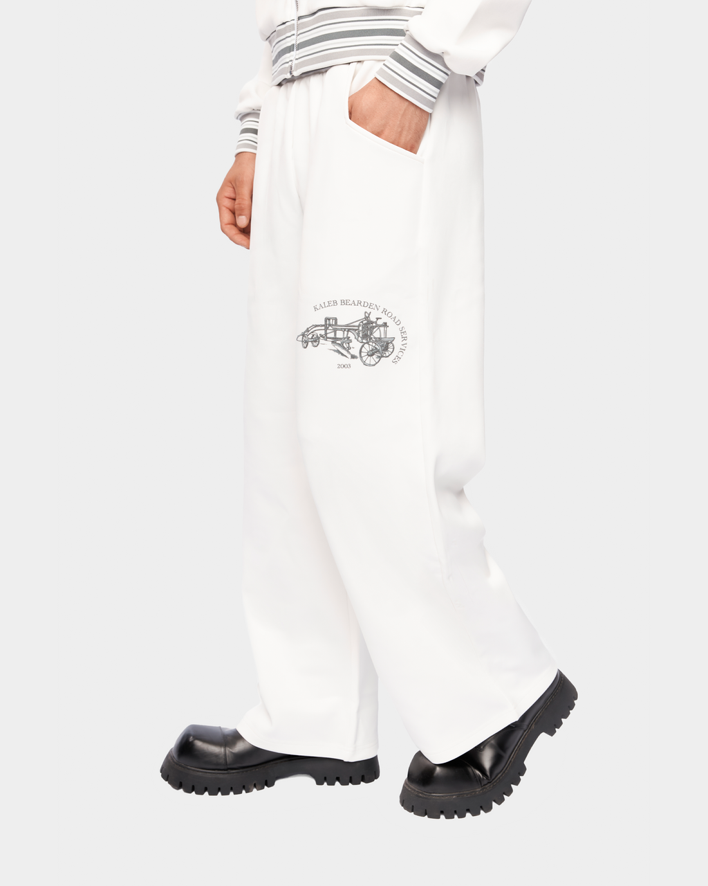 Kaleb A. Bearden Signature Track Pant showing navy blue athletic pants with white side stripes and elastic waistband.
