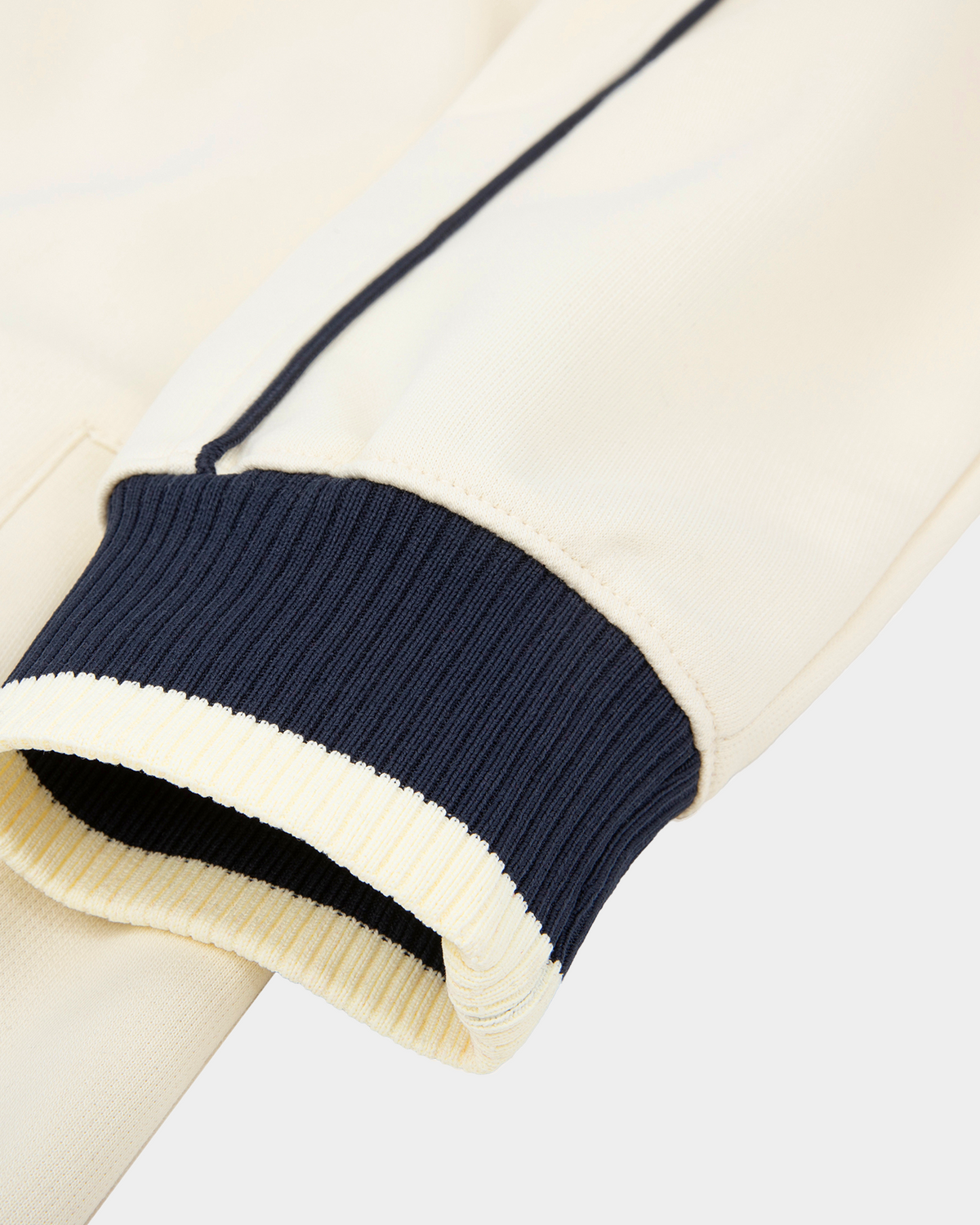 ODMPOD Home Blues Track Jacket featuring a navy blue design with white accents and a sporty, athletic fit.