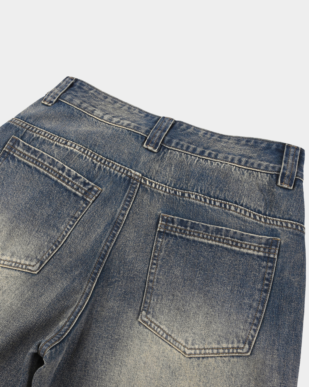 KAB Washed Denim Shorts by Kaleb A. Bearden featuring distressed light blue denim and rolled cuffs on a model.
