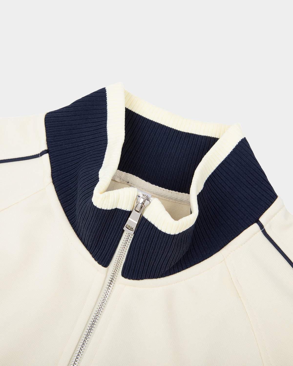 ODMPOD Home Blues Track Jacket in navy blue with white stripe details, shown on a hanger.