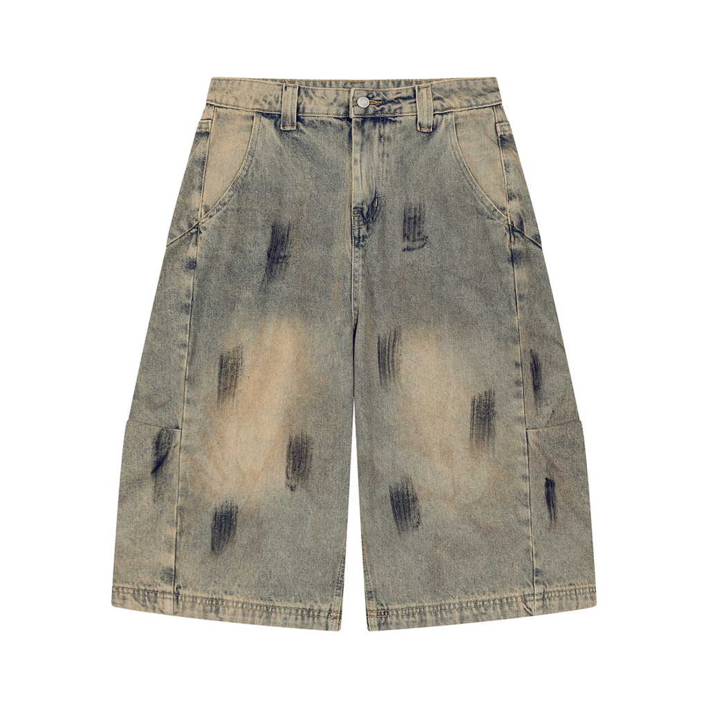 ODMPOD bleach splatter denim shorts with distressed details and frayed hem, showcasing a trendy casual summer look.