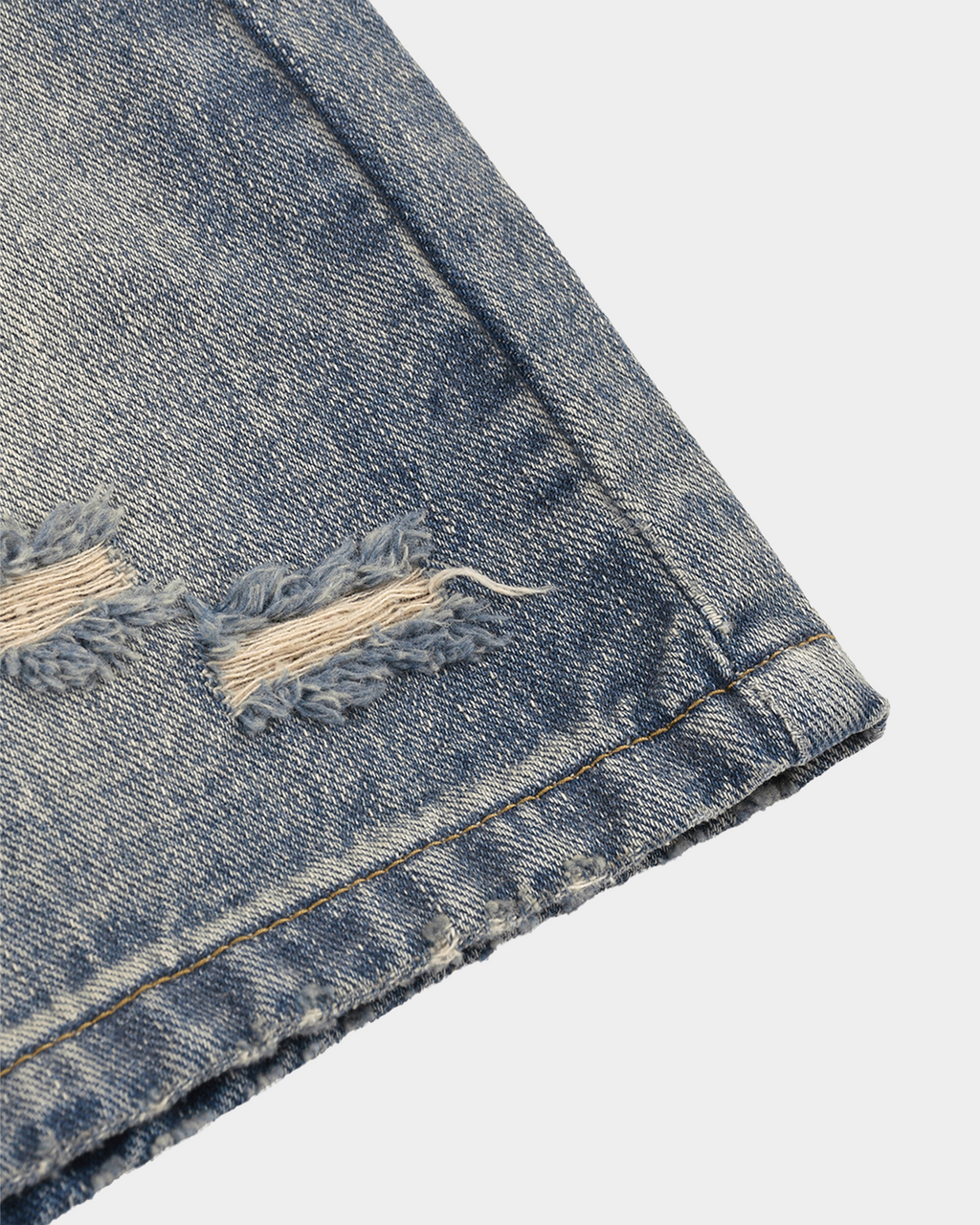Faded baggy denim shorts by Kaleb A. Bearden with distressed details and relaxed fit, shown on a model.