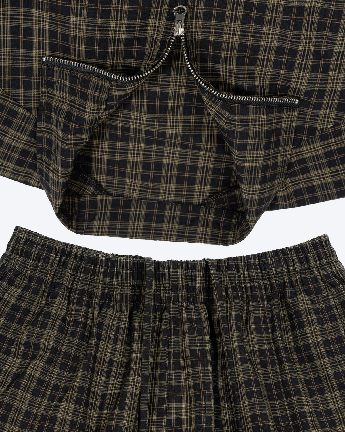 Olive plaid shorts by ODMPOD featuring a casual fit, front pockets, and a stylish plaid pattern for everyday wear.