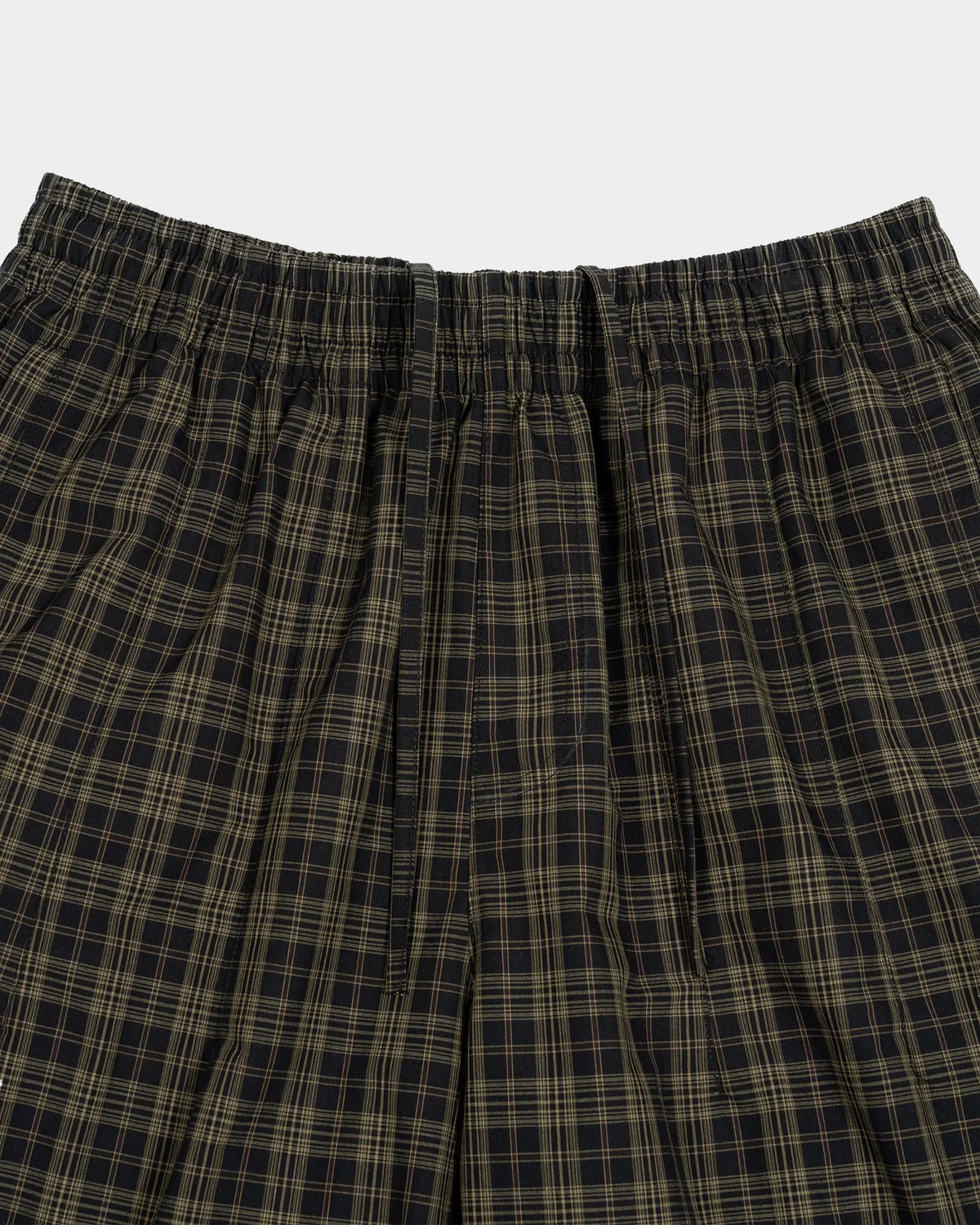 Olive plaid shorts by ODMPOD featuring a stylish pattern and casual fit, displayed on a neutral background.
