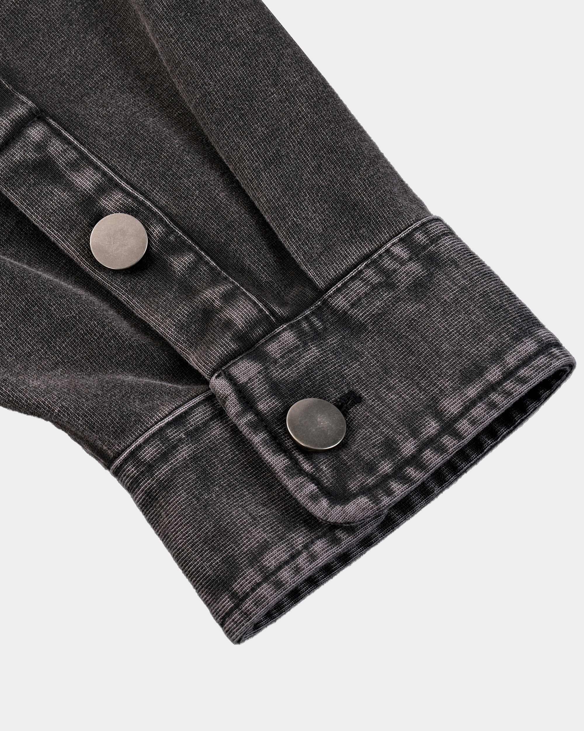 Kaleb A. Bearden Monogram Washed Denim Overshirt displayed on a hanger, showcasing its casual denim fabric and classic design.
