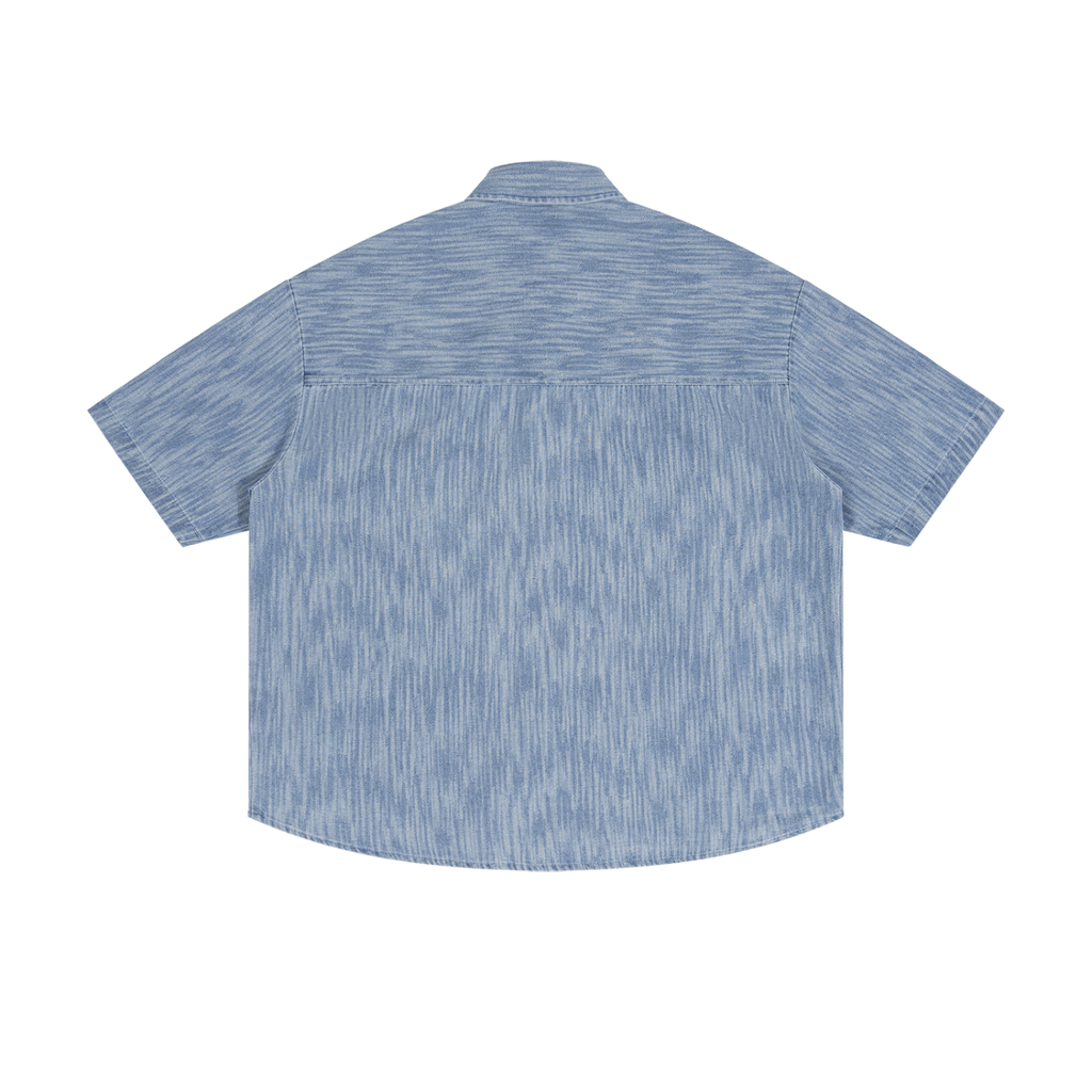 Washed blue Bearden shirt by ODMPOD, featuring a casual fit with a soft, distressed denim look, displayed on a hanger.