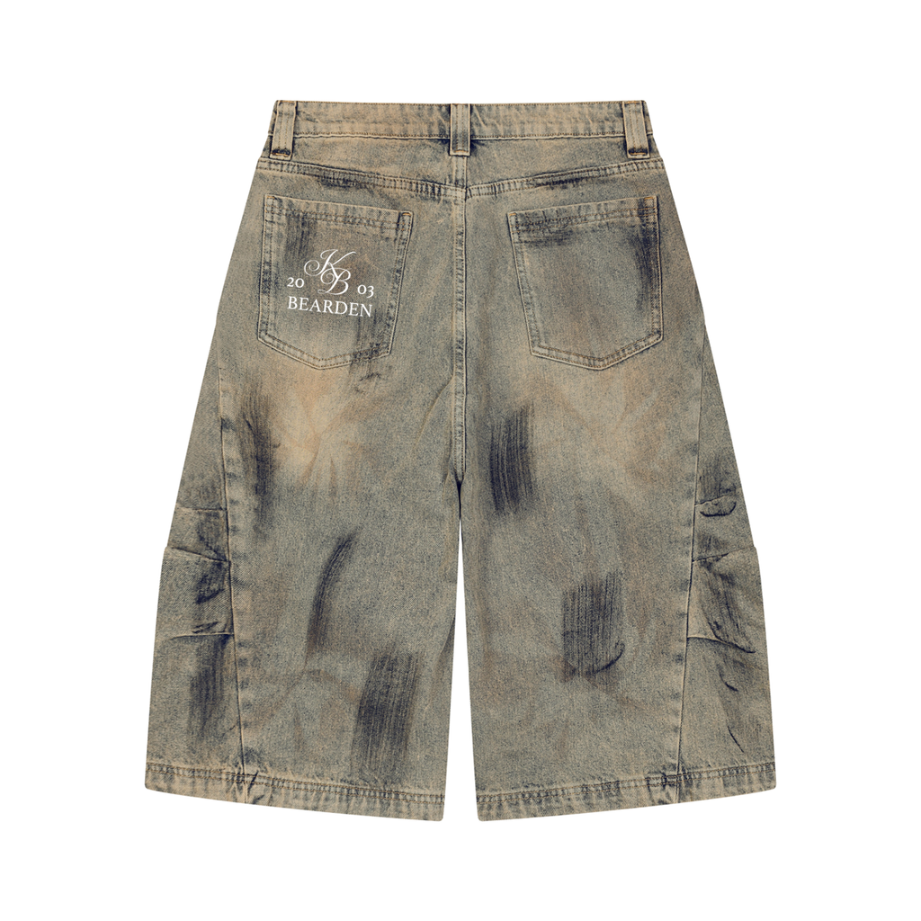 ODMPOD bleach splatter denim shorts featuring distressed, frayed edges and a casual, trendy fit on a model.
