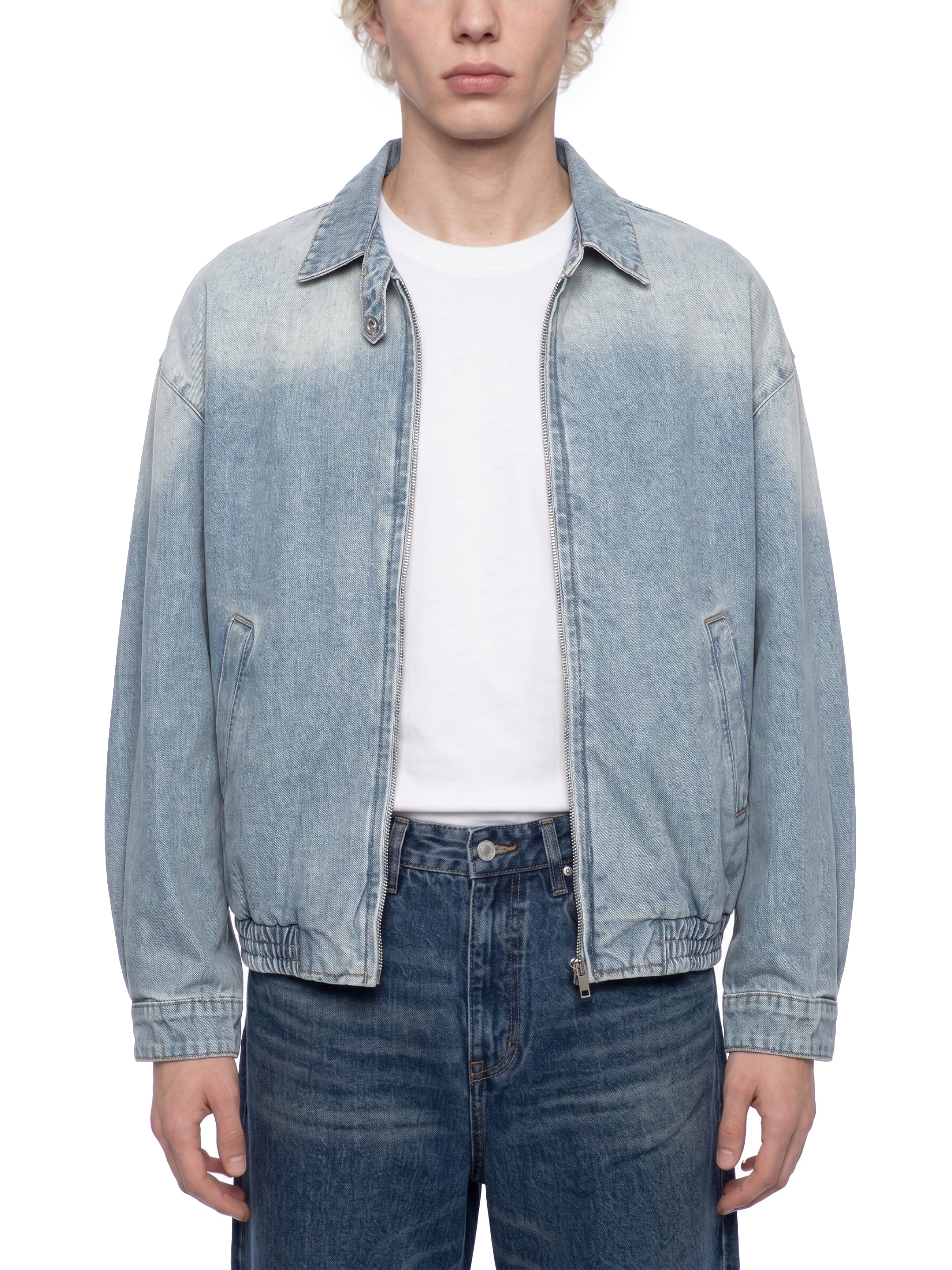 ODMPOD KAB Washed Blouson in light denim, featuring a relaxed fit and casual style, displayed on a hanger against a white background.